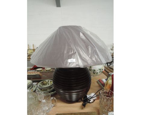 A modern style floor or table lamp and shade