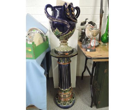 A Vintage majolica jardiniere and stand, with acanthus leaf decoration looped tendrils and regal blue glaze marked 699 FQR 11