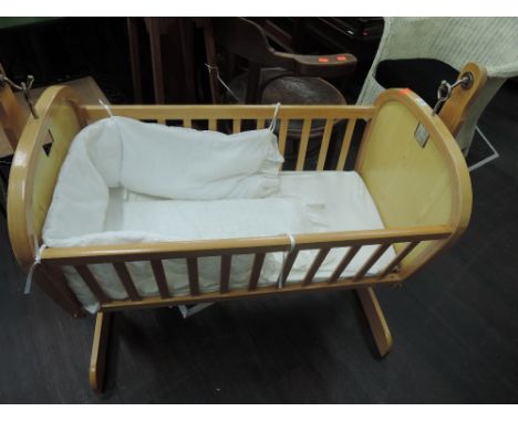 A vintage beech frame cot