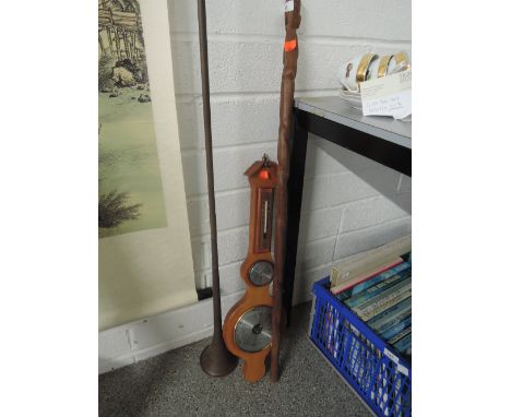 A vintage brass and copper carriage horn, and ethnic carved walking stick with tribal influence