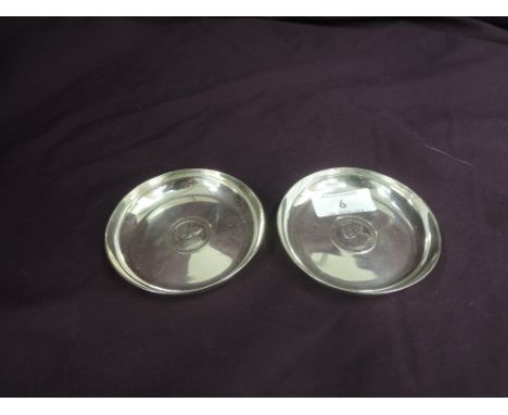 A pair of silver trinket dishes of plain circular form having George V Silver jubilee coin inserts, London 1935, Goldsmiths &