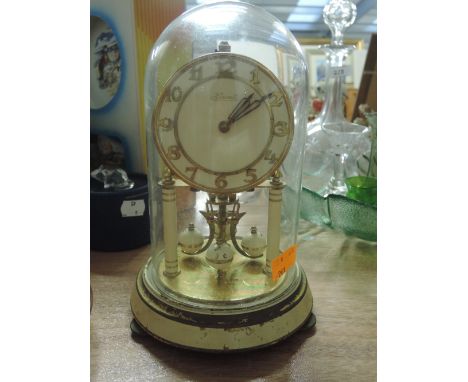 A vintage Hermle anniversary mantle clock with glass dome