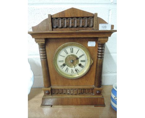 A vintage treen mantle clock with brass and ceramic face by H.A.C no. 3312 made in Wurttemburg