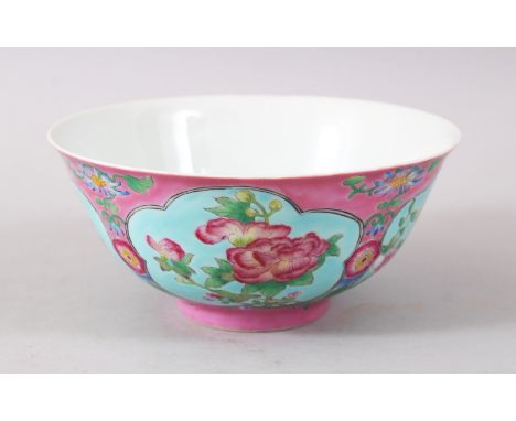 A CHINESE PINK GROUND FAMILLE ROSE PORCELAIN BOWL, the body decorated upon a pink ground with panels of native floral arrange