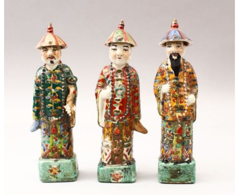 THREE 19TH / 20TH CENTURY CHINESE FAMILLE VERTE PORCELAIN FIGURES, each wearing hats with bead rosary's, stood on pedestal ba