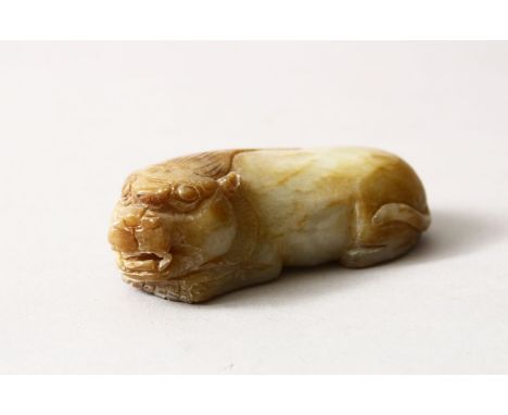 A CHINESE CARVED JADE / HARD STONE FIGURE OF A RECUMBENT KYLIN, 7.5cm.