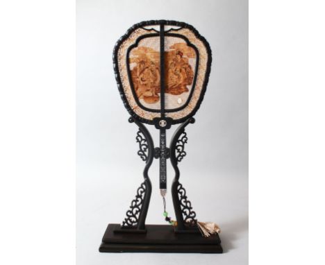 A VERY GOOD CHINESE EBONY, SANDLEWOOD AND IVORY DOUBLE SIDED FAN &amp; STAND, the fan with pierced, carved and stained decora