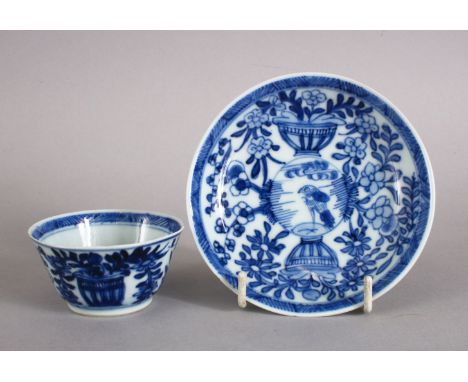 A VERY UNUSUAL CHINESE 18TH CENTURY KANGXI PERIOD BLUE &amp; WHITE PORCELAIN TEA BOWL AND SAUCER, both items with a central r