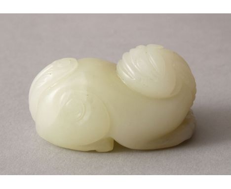 A GOOD 19TH / 20TH CENTURY CHINESE CARVED WHITE JADE  FIGURE OF A MYTHICAL BEAST, the beast recumbent, 6cm wide.