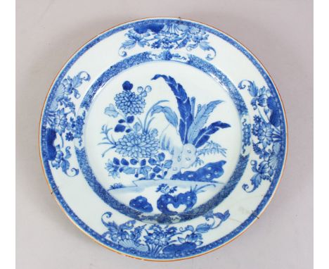 A 19TH CENTURY CHINESE BLUE &amp; WHITE PORCELAIN PLATE, with native floral decoration, metal hanging bracket, 28cm diameter.