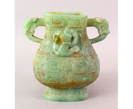 A CHINESE CARVED JADE LIKE HARD STONE TWIN HANDLE ARCHAIC STYLE VASE, carved in archaic style with chilong ad mythical mask h