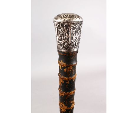 A GOOD 19TH CENTURY CHINESE WHITE METAL TOPPED WALKING CANE, The stick carved in bamboo style, with a white metal floral embo