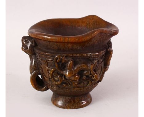 A CHINESE CARVED HORN LIBATION CUP, The cup carved in relief with chilong over archaic design, base with a seal mark, 11.5cm 