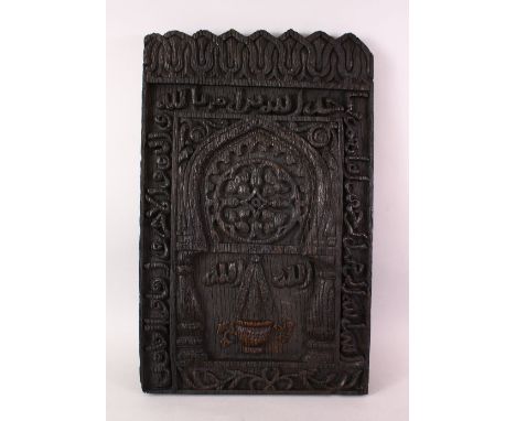 A GOOD 19TH CENTURY OR EARLIER IRANIAN MIRIHAB CARVED WOODEN PANEL, carved with calligraphy and a central suspention, 50cm x 