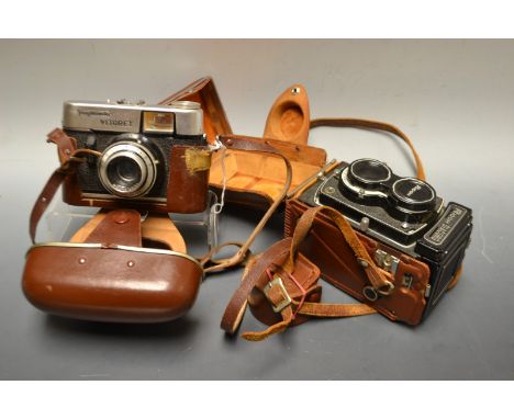 A Ricoh Diacord camera; a Voigtlander Victory camera