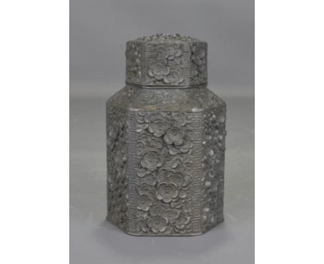 A 19th century Chinese pewter tea caddy decorated around with a floral design. 13cm tall 