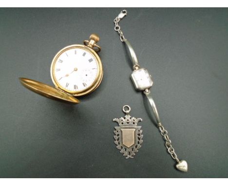 A silver hallmarked fob medal Birmingham 1902. A gold plated pocket watch a/f case by Dennison (with Sun, Moon and Star trade