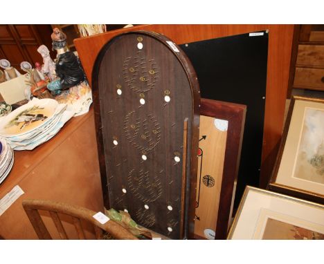 A bagatelle board and a House of Marbles game