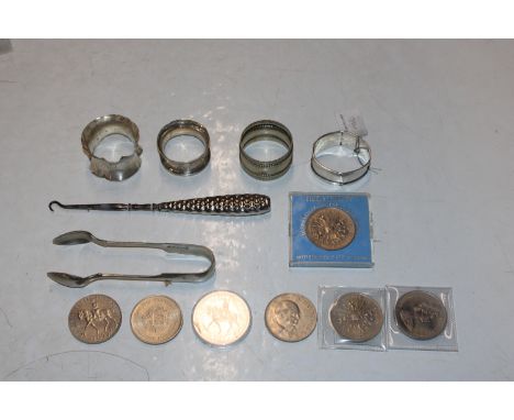 Three silver napkin rings; a silver plated napkin ring; a pair of silver plated sugar tongs; a button hook and various coinag