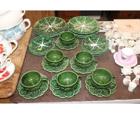 A quantity of Green leaf plates, cups and saucers 