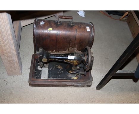 A Singer hand sewing machine in fitted case
