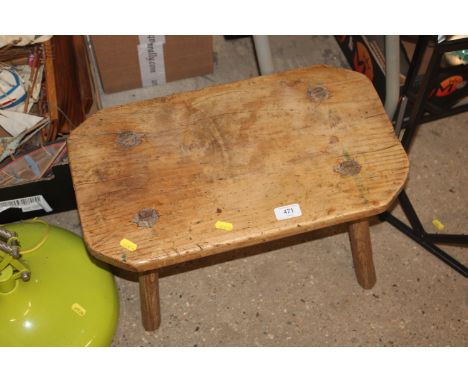 A rustic oak four legged stool