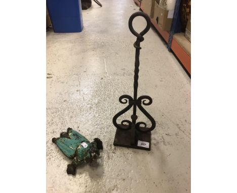 A wrought iron door porter 40.5 cm high together with a Victorian wrought iron boot jack (jack missing) in the form of a bug 