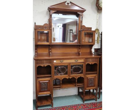 A late Victorian mahogany mirrored back display cabinet with architectural surmount over central bevelled glass mirror flanke