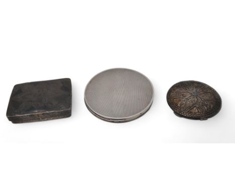 A silver compact, Birmingham, with engine-turned decoration, a white metal filigree compact, and a white metal box, with engr