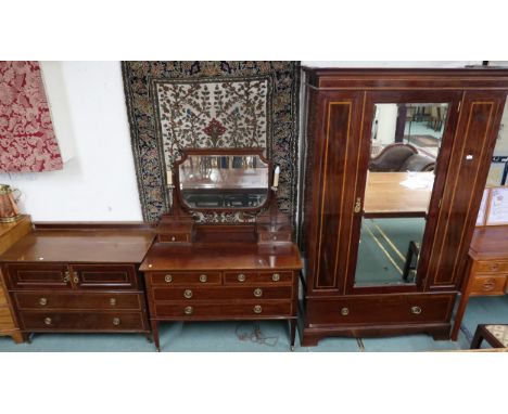 An Edwardian mahogany bedroom suite comprising mirror doored wardrobe, 210cm high x 131cm wide x 58cm deep, mirror backed dre