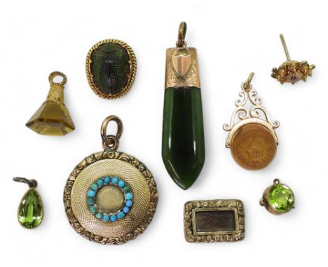 A collection of gold and yellow metal items to include, a turquoise set locket, a New Zealand jade pendant, scarab beetle stu
