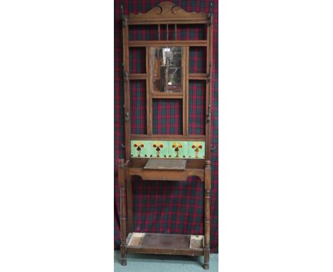 A late Victorian oak hall stand with bevelled glass mirror over tiled splash back and paired umbrella stands, 200cm high x 69