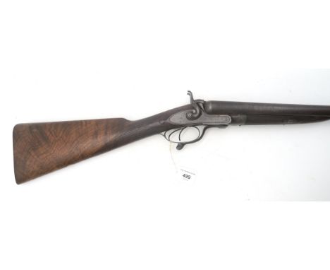 A 12 bore double-barrelled shotgun with lock plates engraved Army &amp; Navy C.S.L., having a nicely figured walnut stock, wi