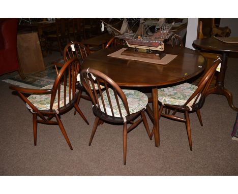 An Ercol drop leaf dining table and six chairs to include: two open arm chairs and four single chairs each with squab cushion