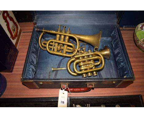 An old clarinet in fitted case, the clarinet stamped 'Regent'; together with two brass trumpets, one by Lessons & Co; the oth