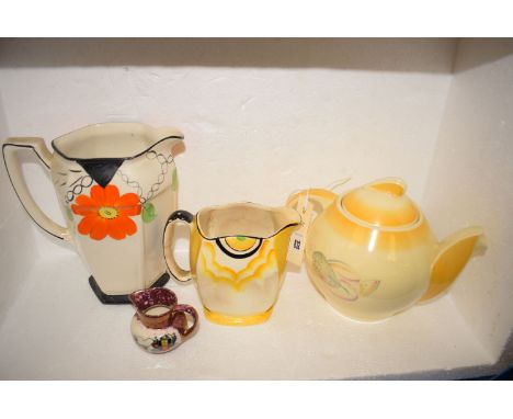 Four pieces of early 20th Century ceramics, comprising: Grey's pottery miniature cream jug decorated a coaching scene; a Crow