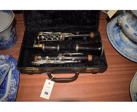A Boosey & Hawkes ebonised wooden clarinet in fitted case.