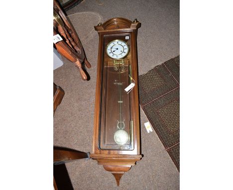 A mahogany framed Vienna style wall clock with white enamel roman dial.
