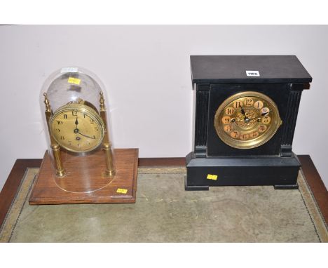An ebonised cased mantel clock with arabic brass dial; together with another clock on an oak base.