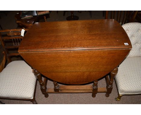 An oak drop leaf table fitted gate leg action.