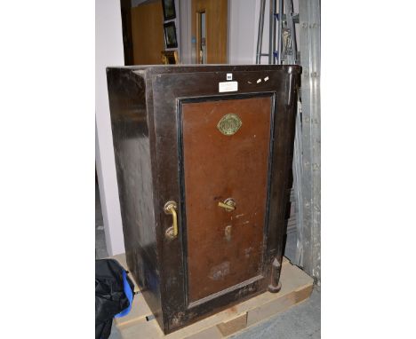 A Chubb floor standing safe, the heavy panel door with brass handle opening to reveal interior adjustable shelf, with origina