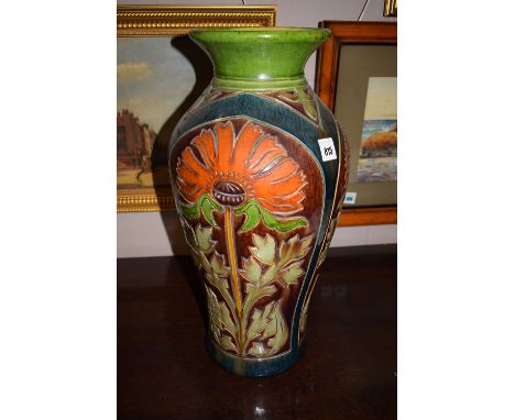 An Arts & Crafts style ceramic vase, incised coloured glazed stylized floral decoration depicting flowers in three panels, gl