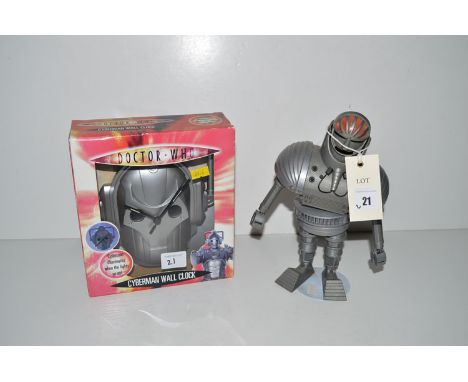 A Giant Robot figure mounted on stand, c.1970; together with a Cyberman wall clock, boxed.  (2)