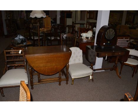 An Edwardian corner chair with upholstered back and seat; together with a button back chair and with gilt turned legs and bra