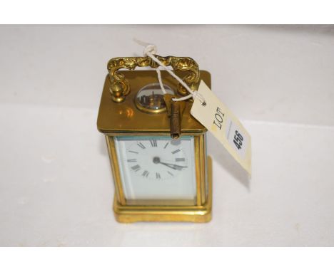 An early 20th Century brass carriage clock with enamel roman dial.