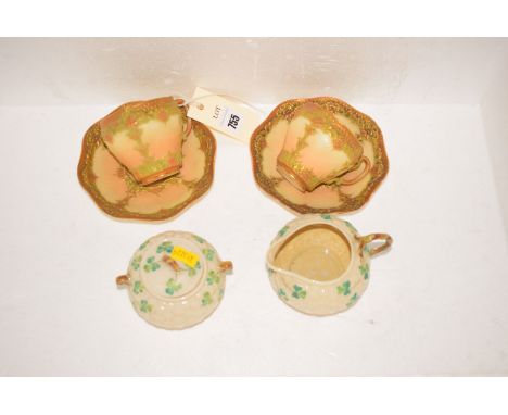 A pair of early 20th Century Royal Worcester specimen teacups and saucers, pattern no. 1933, the Worcester marked inscribed i