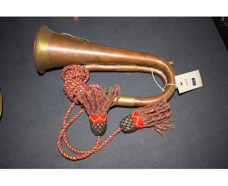 A copper and brass bugle, with brass military crest inscribed "London Welsh Fusiliers" (no mouthpiece).