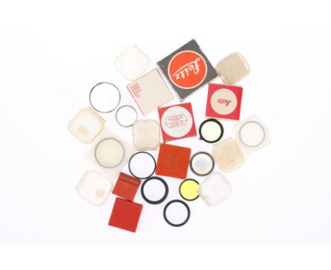 A Selection of Leica and Leitz Related Camera Accessories to include filters, filter cases, and rings, as a lot.