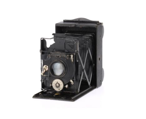 An Adams Vesta Folding Film Plate Camera black, serial number 165, bellows extends but not light checked, shutter works but s
