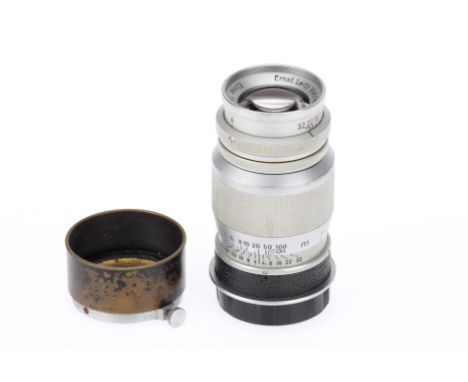 A Leitz Wetzlar Elmar f/4 9cm Camera Lens, chrome, serial no. 983801, body F-G, paint wear to hood, elements, G, with very li